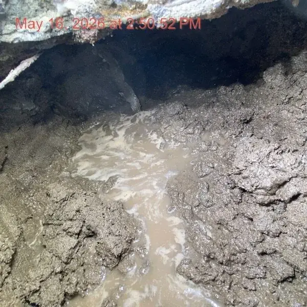 Before — Slab access point opened, pipe failure exposed — Kingdom Plumbing LLC